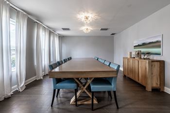 A dining room with a wooden table and blue chairs
